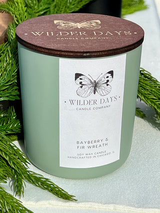 Luxury soy candle with X wood wick in a matte sage vessel. Bayberry & Fir Wreath scent with notes of fir, eucalyptus, bayberry, and cedarwood by Wilder Days Candle Company in Chicago.