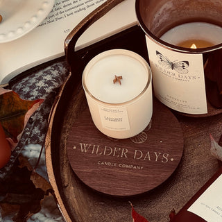 Hand-poured soy candle with X wood wick in chic glass vessel. Cashmere & Embers fragrance with notes of vanilla cream, amber, smoky birch, and cedarwood by Wilder Days Candle Company in Chicago.